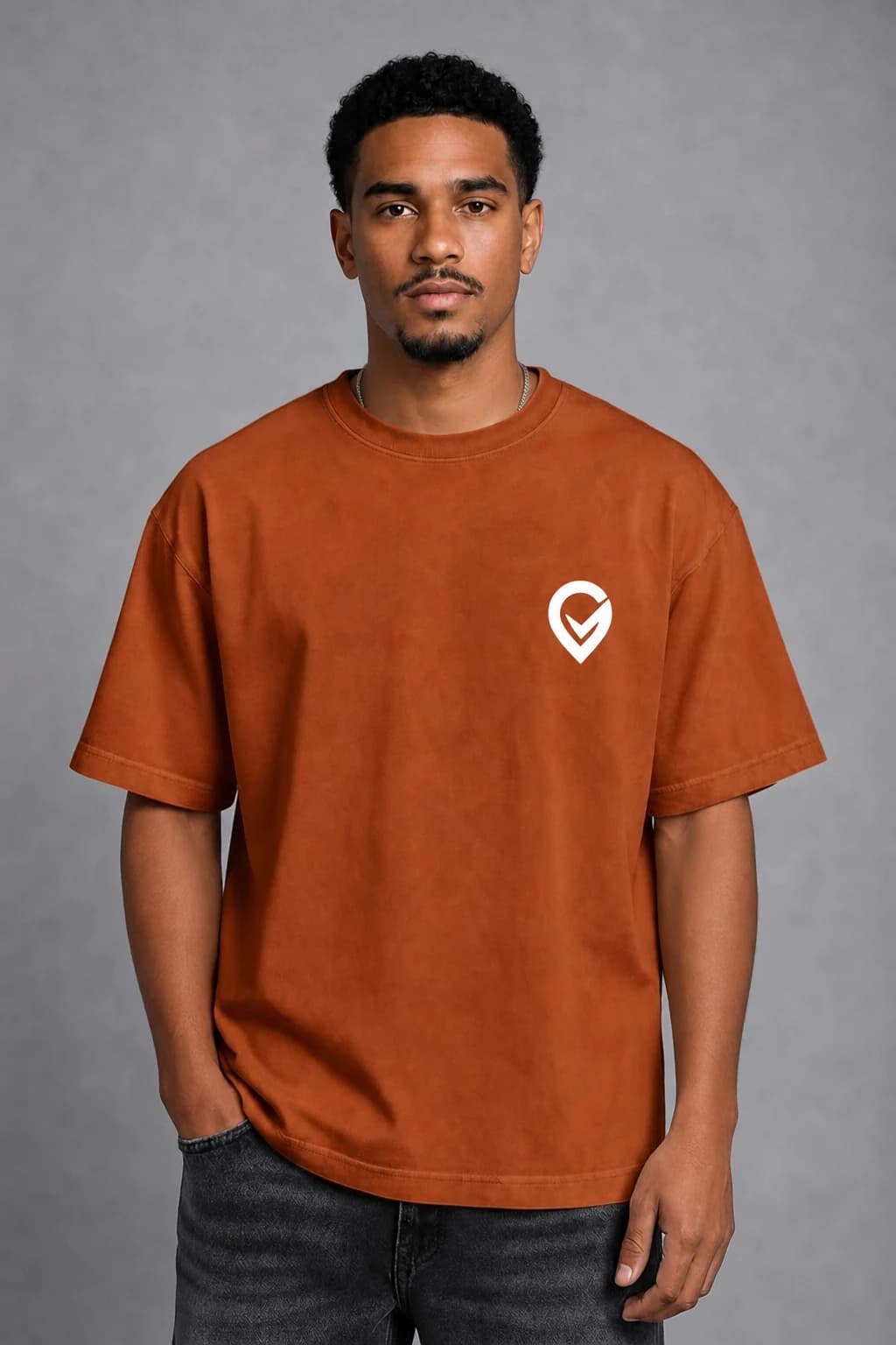 A man wearing an orange Trurep shirt with the white logo
